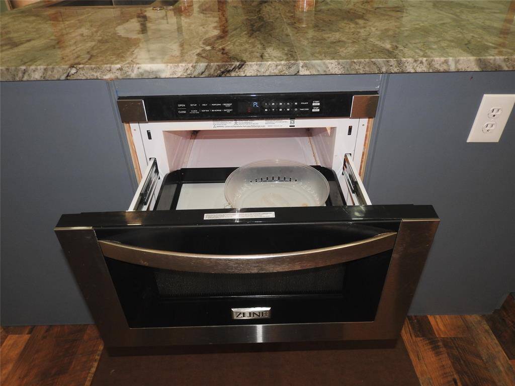Microwave is under the Kitchen Island. Out of the way....