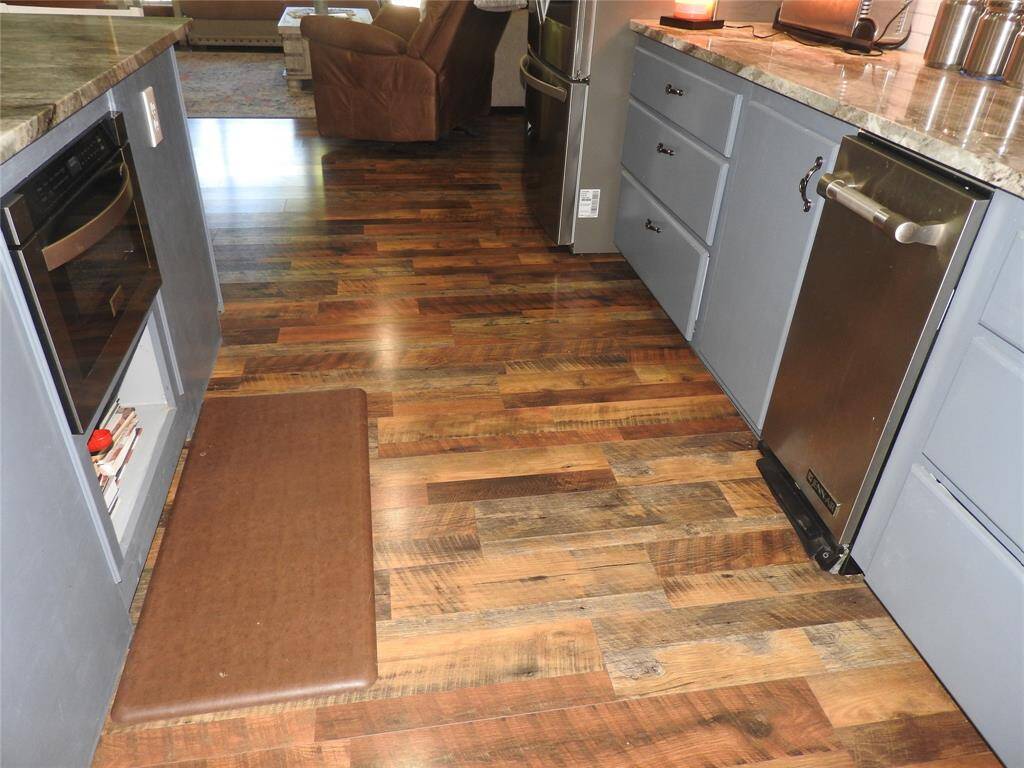 Microwave is on the left and the trash compactor is on the right. The distance between the Kitchen Island and Counter meet Disability Act for Wheelchair Access.-No, no one here is disable, but lots of thought was considered when building this Custom gorgeous home.