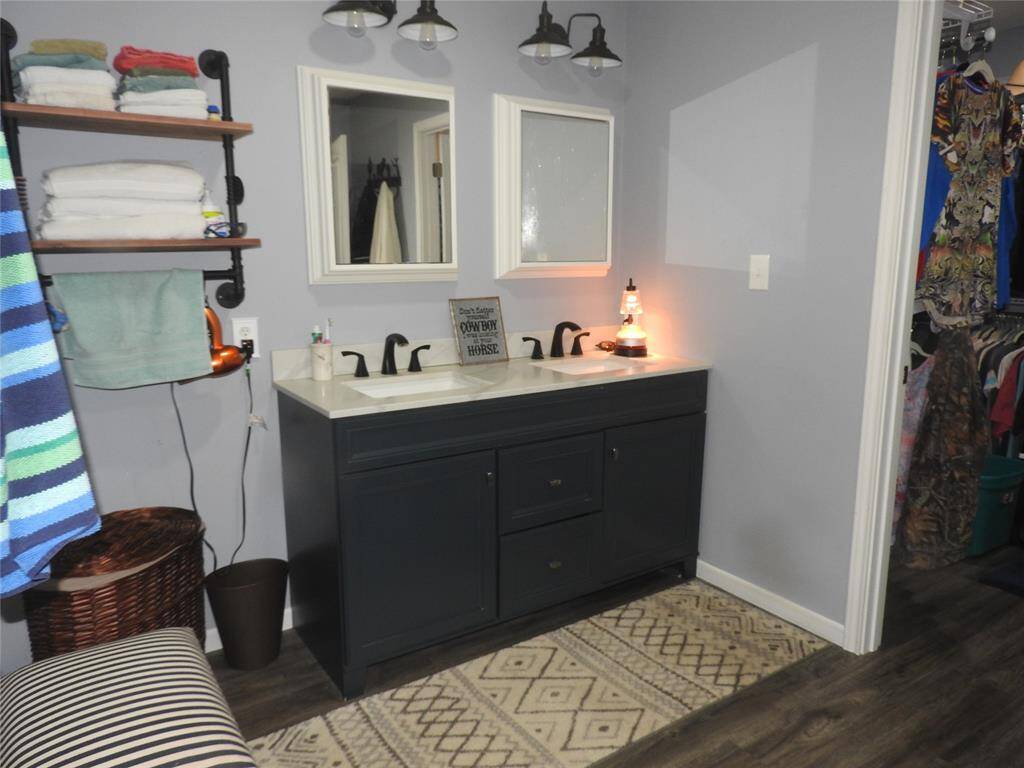 On one side of the shower; Vanity with Double Sink and Mirrors.