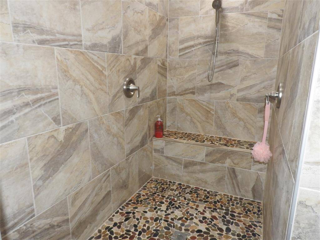 Another view of this Custom shower with a seating bench.