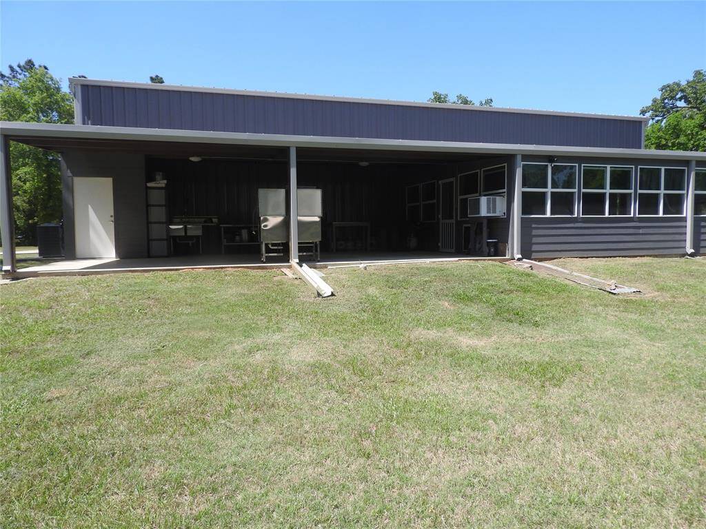 Side of the back porches; Grilling area, enclosed porch with family room. Door to the left is a half bath.