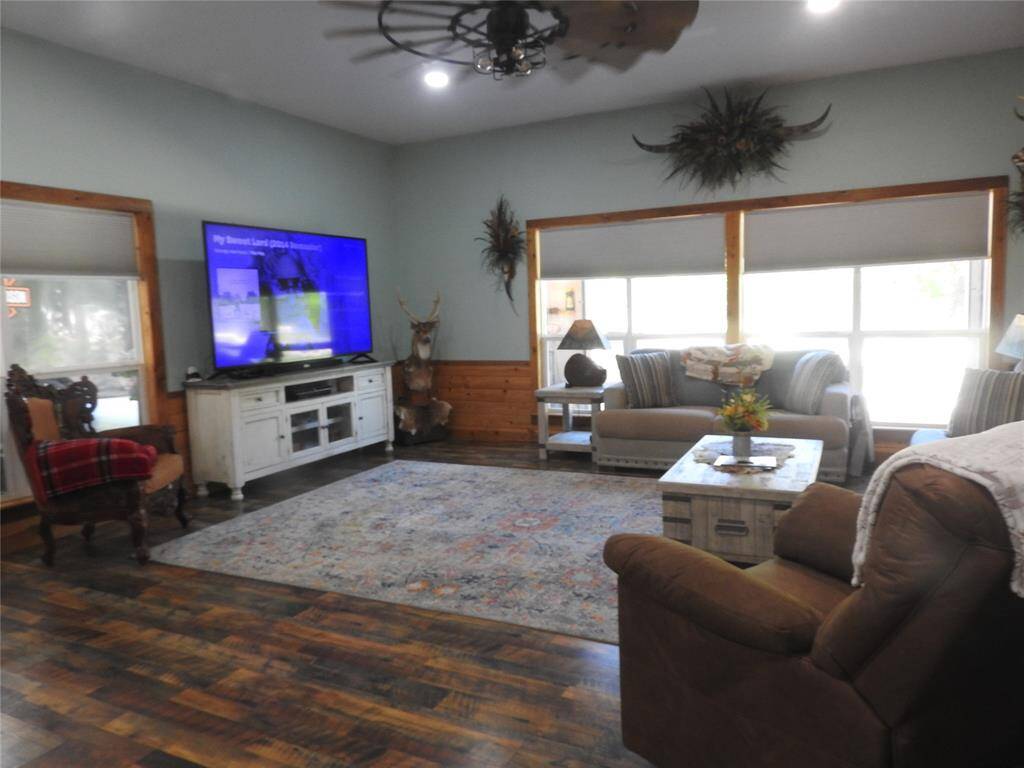 This space is an Open Concept to the Kitchen and Eating area. Window faces front of home/entry gate & parking space under carport.
