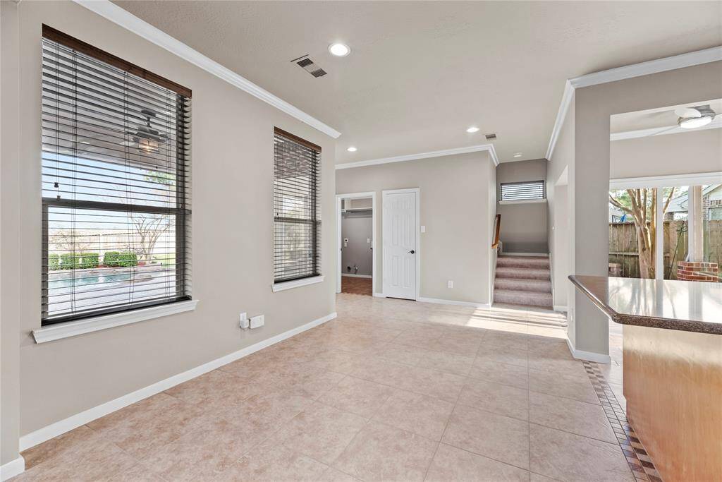The breakfast room is ideal for a full-sized table and features easy care tile floors and large bright windows giving picturesque views of the backyard.
