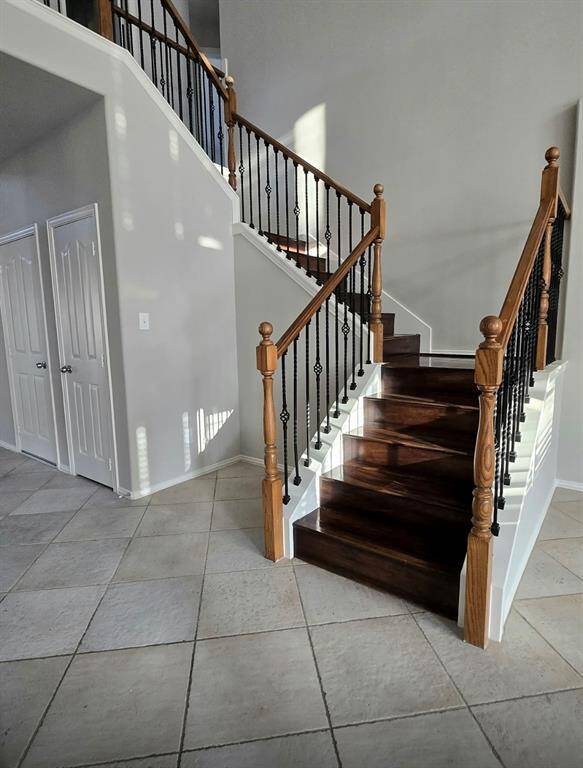 Wooden stairs with wrought iron spindles. Lots of natural light through out the home