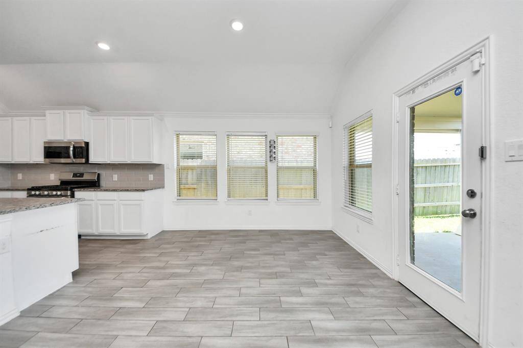Just off the kitchen, a dedicated dining space provides the ideal setting for both casual meals and formal gatherings.