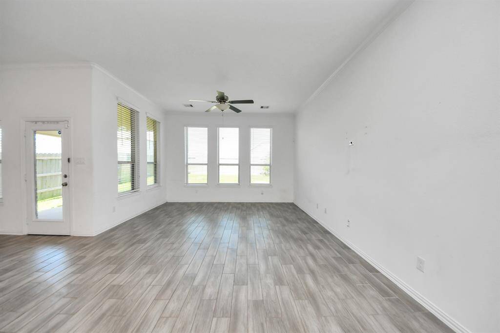 The abundance of windows not only fills the space with sunlight but also offers scenic views of the backyard, creating a perfect blend of indoor comfort and outdoor beauty.