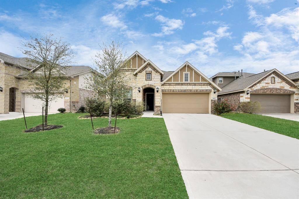 The front exterior showcases a beautiful blend of brick and stone, offering a timeless and elegant look with warm, inviting tones.
