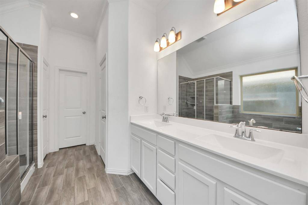 Dual vanities with two sinks provide plenty of counter space and personal storage, making morning routines a breeze.