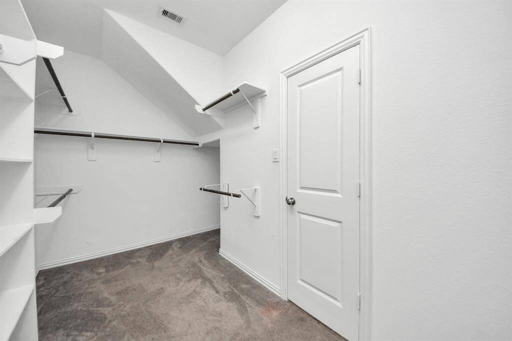 A generous walk-in closet completes the suite, offering ample room for wardrobe organization and additional storage.