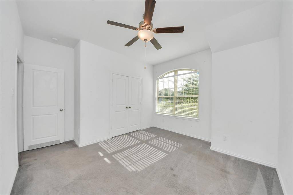 Back on the main floor, the three secondary bedrooms are thoughtfully arranged to provide comfort and privacy.
