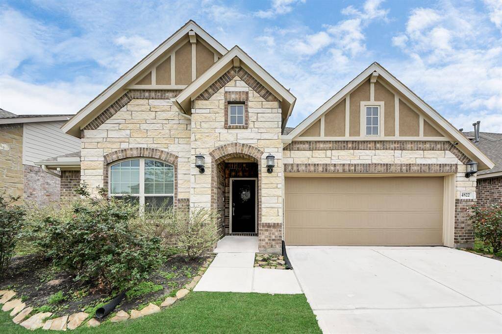 A spacious two-car garage provides ample parking and storage, seamlessly integrated into the home’s design.