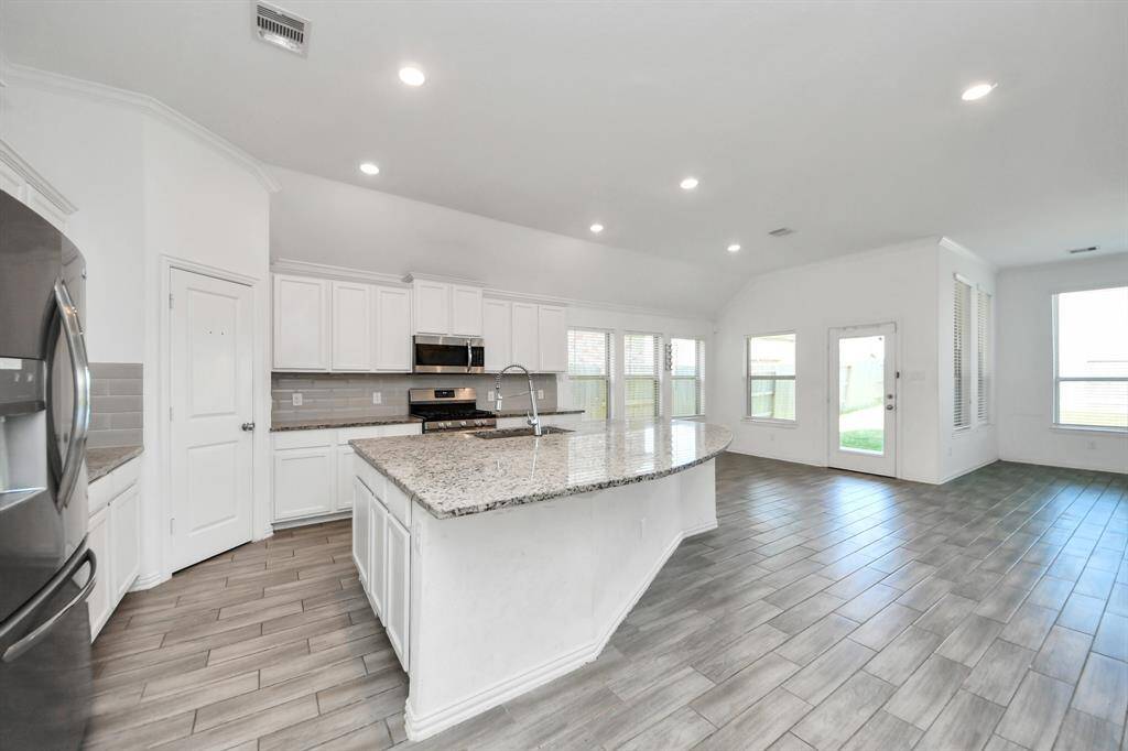 The kitchen is a true showstopper, featuring a large center island with a built-in breakfast bar.