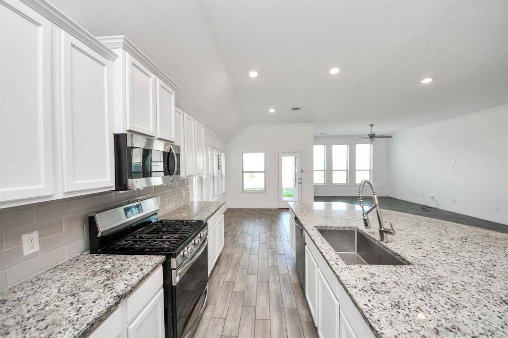 Sleek countertops and abundant cabinetry offer plenty of storage and workspace, while modern appliances and thoughtful design touches ensure both style and function.
