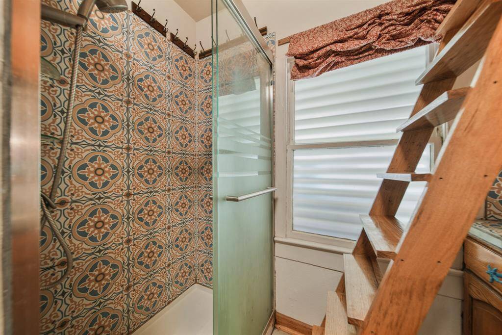 Walk-in shower with beautiful tilework.