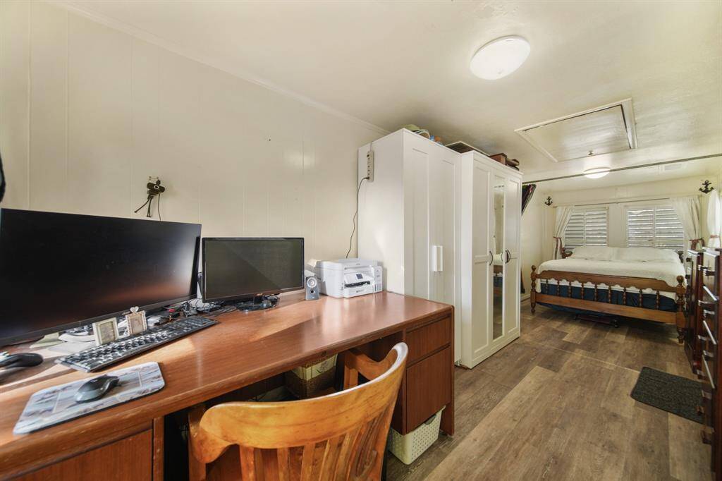 The flex room is spacious, with the left side set up as a home office and the right featuring an extra bed for you or your guests.