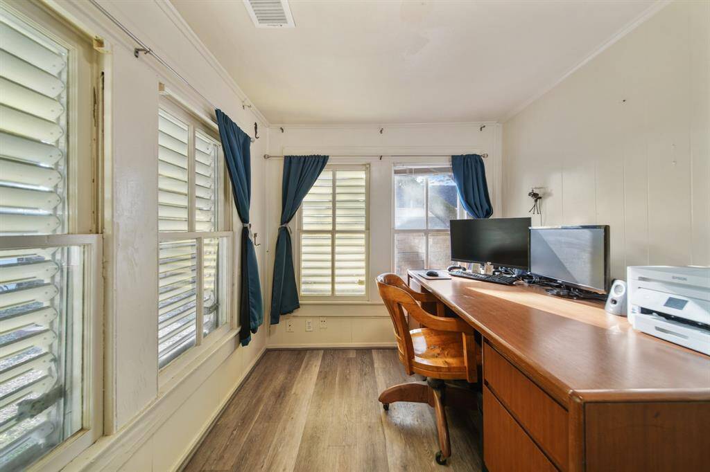 The flex room is spacious, with the left side set up as a home office and the right featuring an extra bed for you or your guests.