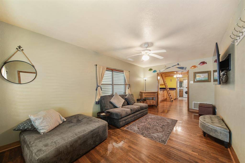 Standing at the entry, looking through the living room, dining area, and into the kitchen