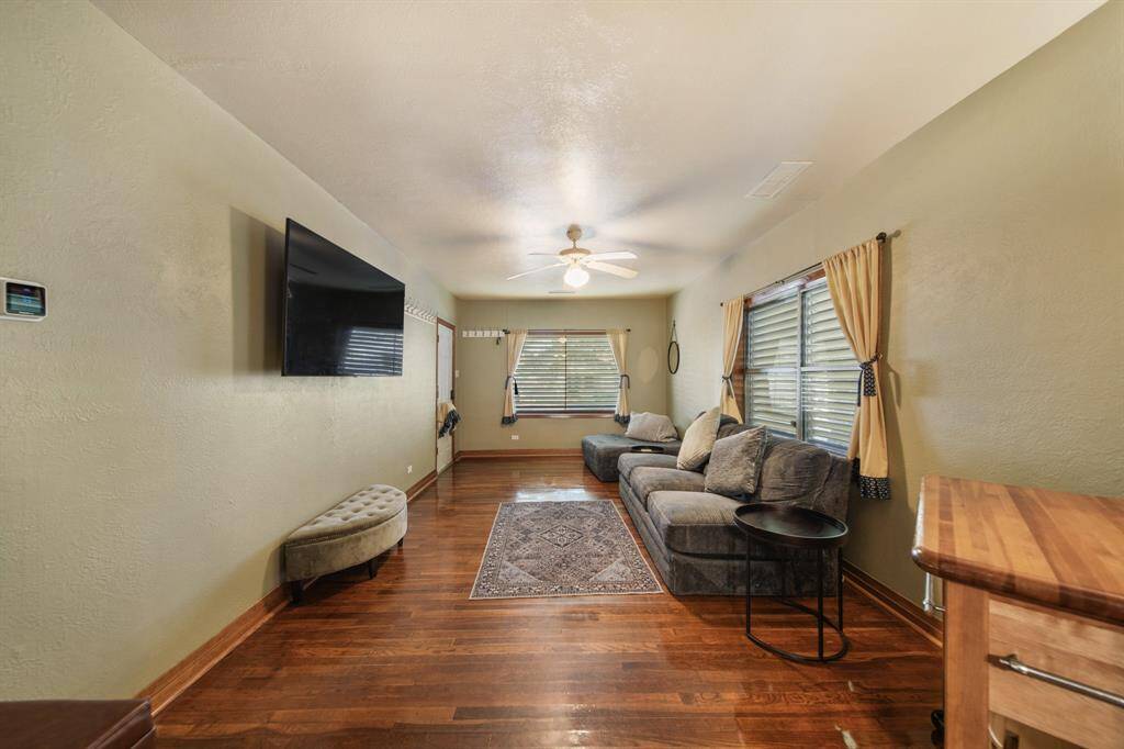 From the kitchen or dining room, you can see into the living room with large windows that let in plenty of natural light.
