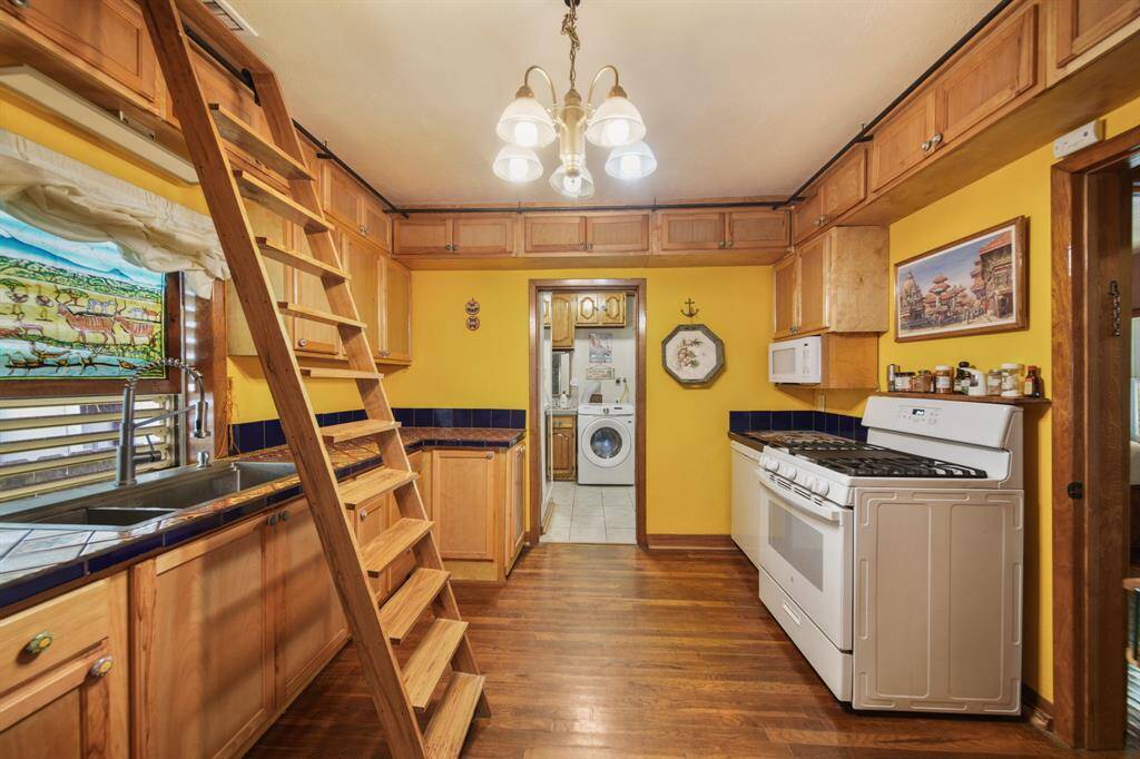 A custom stair system that allows for left right movement and providing easy access to areas above the cabinets for retrieving items as needed