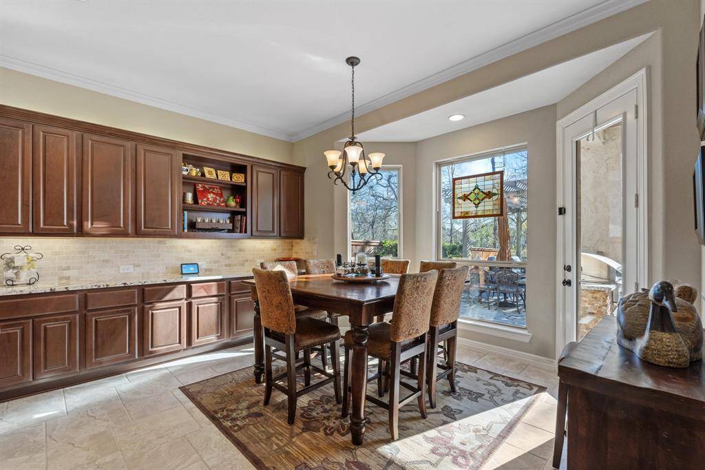 The charming breakfast room with built-in storage and a bay window that brings in natural light, offering easy access to the backyard. Ideal for casual meals or enjoying morning coffee.