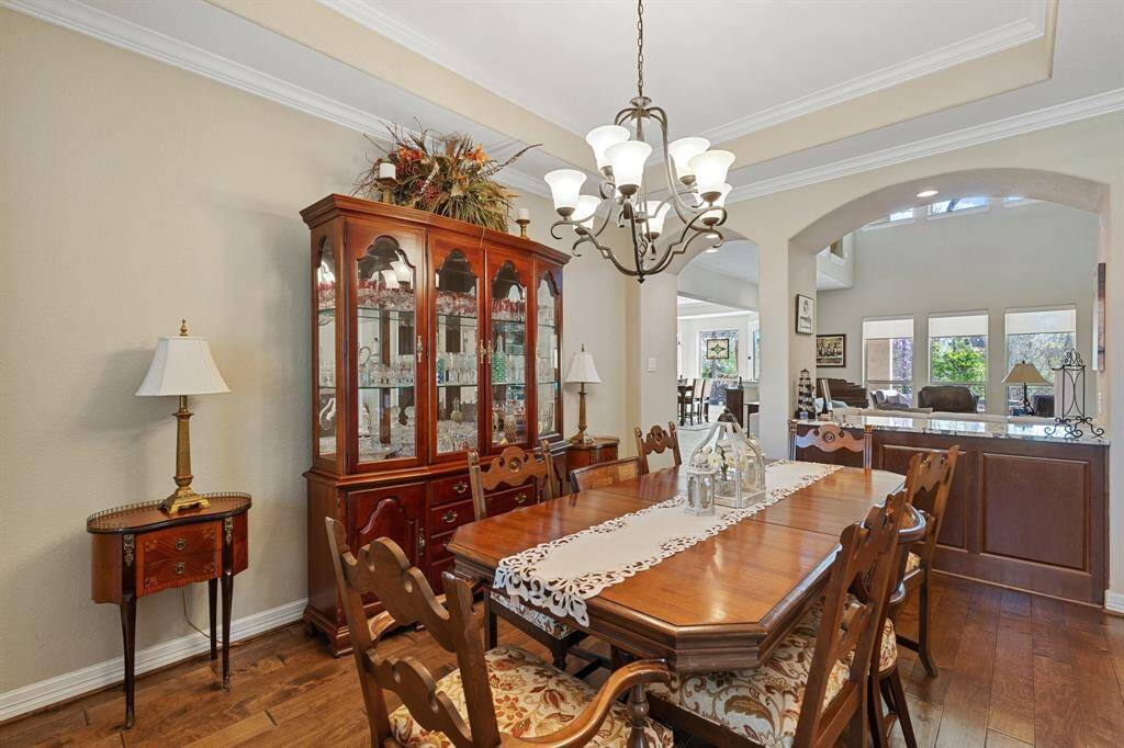 With a chandelier, built-in counter space for serving, and abundant natural light, this dining room offers a warm and inviting atmosphere for hosting family and guests.