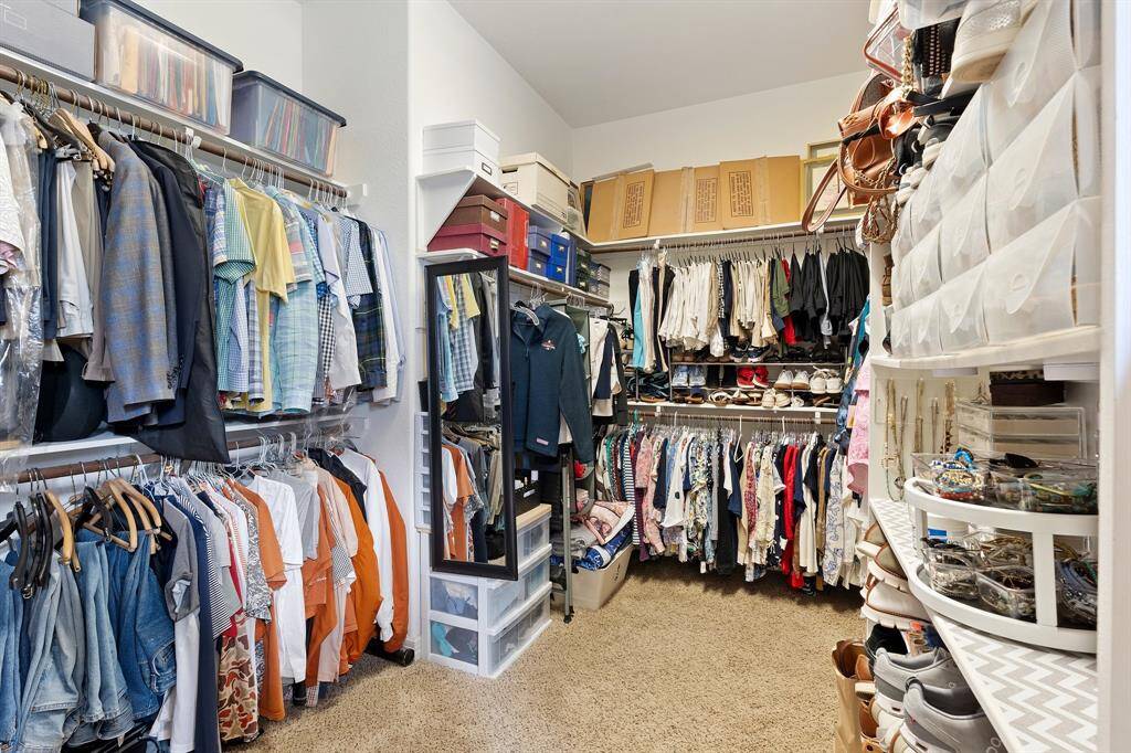 Impressive closet featuring built-in shelves and storage. Thoughtfully designed for both convenience and style, complementing the home’s luxury elements.