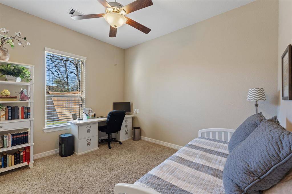 Main floor guest suite, ideal for multi-generational living. Featuring an oversized window, plush carpet, and neutral finishes, this suite creates a welcoming and serene atmosphere.