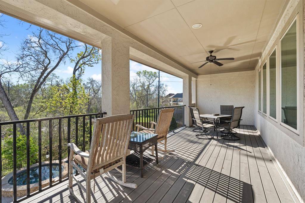 Lovely second-floor balcony, accessible from the secondary living space, offers a peaceful retreat with stunning views of the serene wooded landscaping. A ceiling fan adds comfort, making it an ideal spot to relax and enjoy the natural surroundings. Whether you're unwinding after a long day or enjoying morning coffee, this balcony provides a perfect blend of privacy and tranquility.