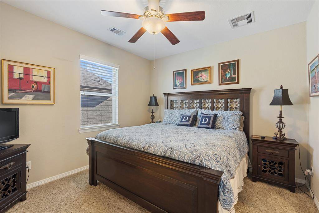 Spacious secondary bedroom featuring a walk-in closet, oversized windows, and convenient access to a Jack and Jill bathroom. Natural light fills the space, creating a bright and inviting atmosphere.
