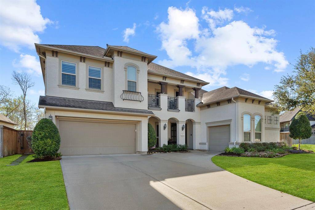 A picturesque view of this beautiful home’s exterior highlights the expansive driveway leading to the impressive three-car garage. Lush landscaping and clean lines create an inviting atmosphere, setting the stage for the elegance found inside.