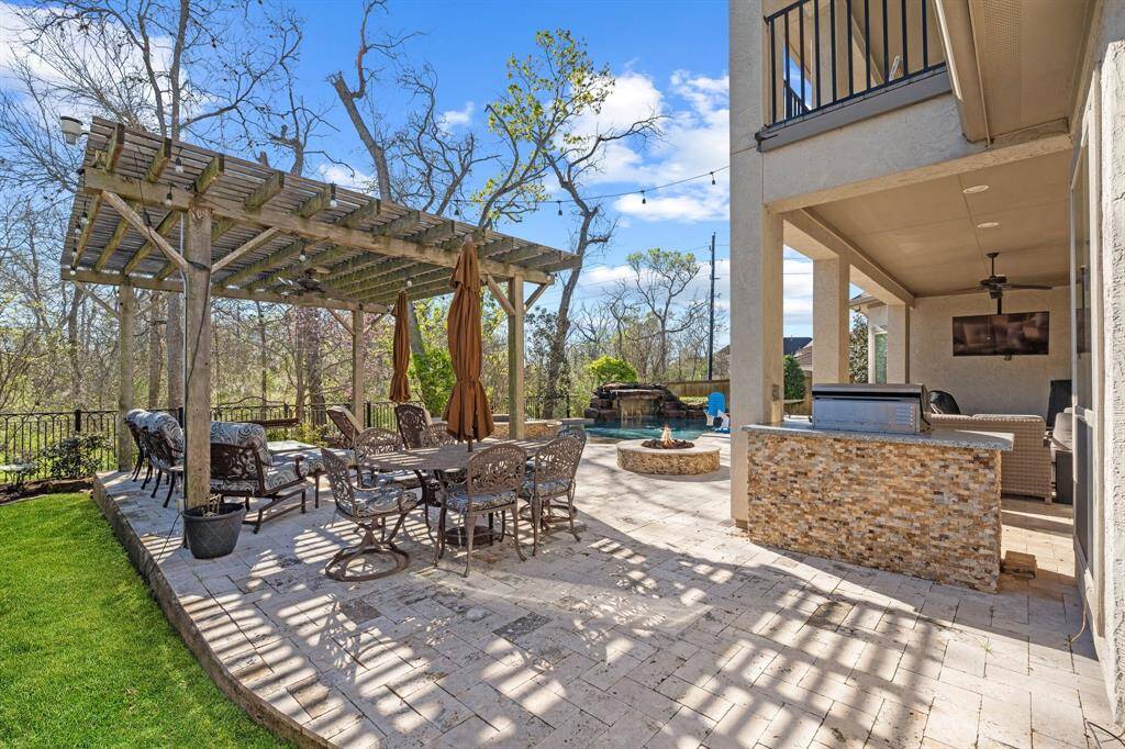 The beautiful pergola creates a shaded retreat perfect for relaxing or entertaining. The built-in fire pit adds warmth and ambiance, making it an ideal spot for cozy evenings under the stars.