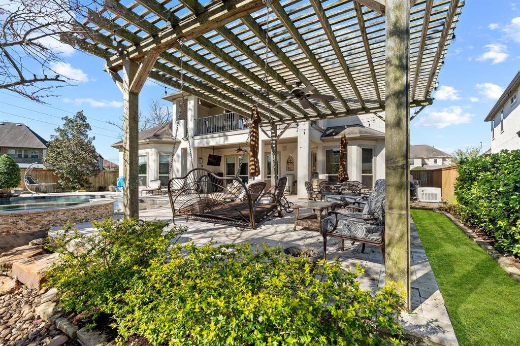 Lush landscaping enhances the tranquility, creating a private oasis to relax, read, or simply enjoy nature. Whether for quiet reflection or casual conversations, this inviting corner of the home provides both comfort and beauty.