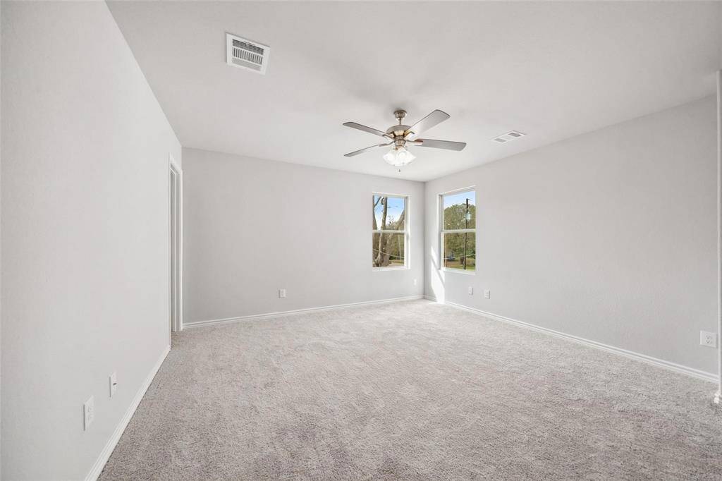 The first bathroom is bathed in natural light and features a spacious shower/tub combo.