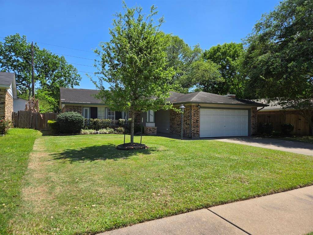 Charming single-story home with a well-maintained lawn and mature trees. Features a two-car garage and a welcoming front yard, perfect for families.
