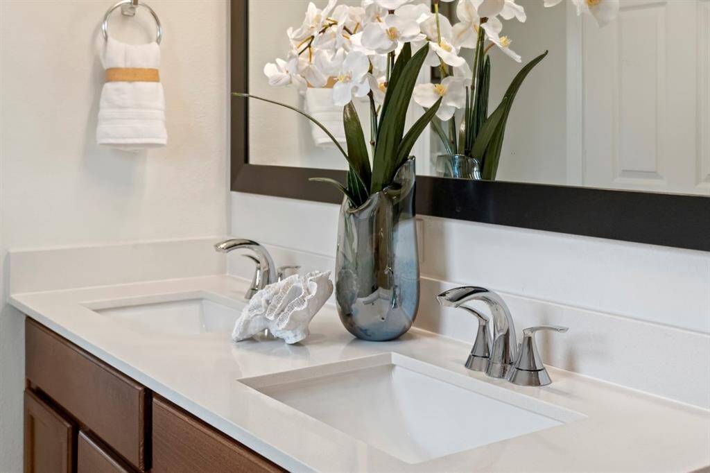 The dual vanity sinks with Moen Seena Bathroom Faucets in Chrome!