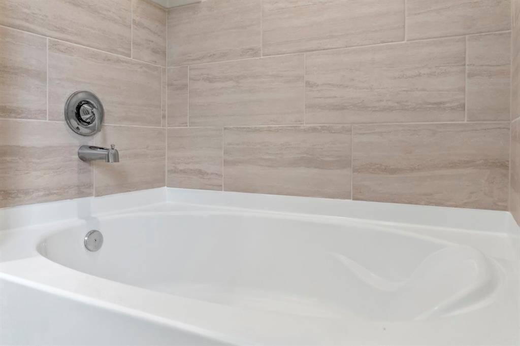 The primary bathroom comes with a 42" tub/shower combo with tile surround.