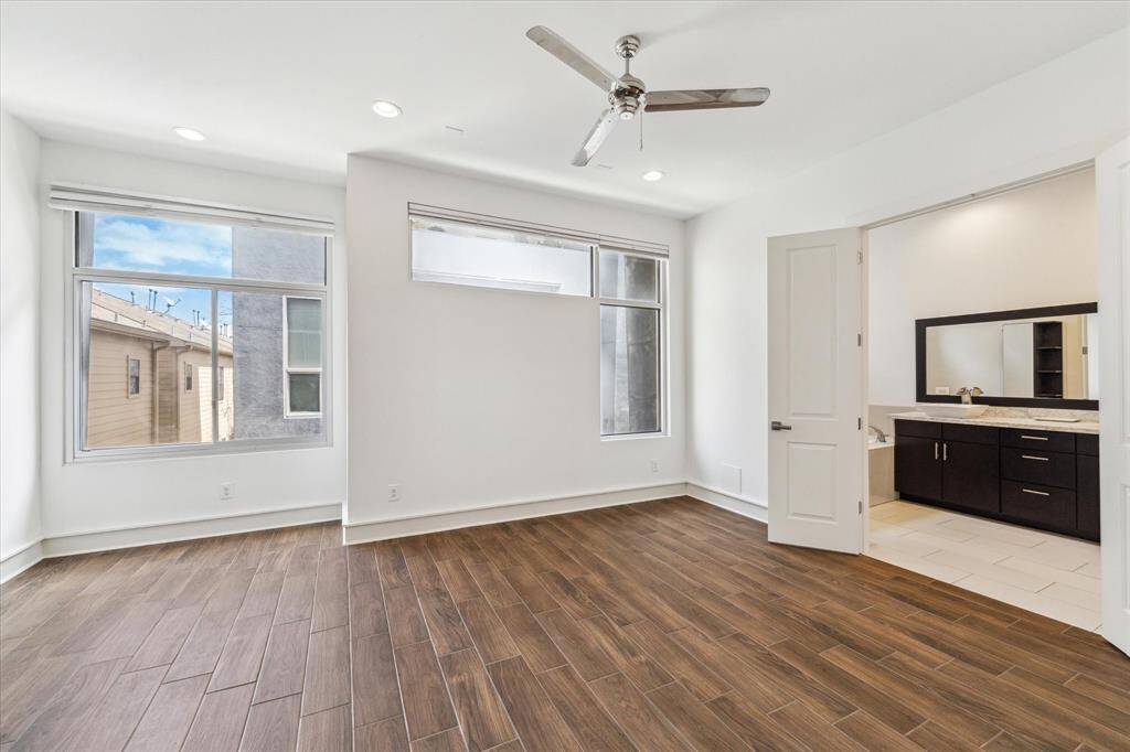 The gorgeous contemporary features are continued in the primary bedroom and bath.