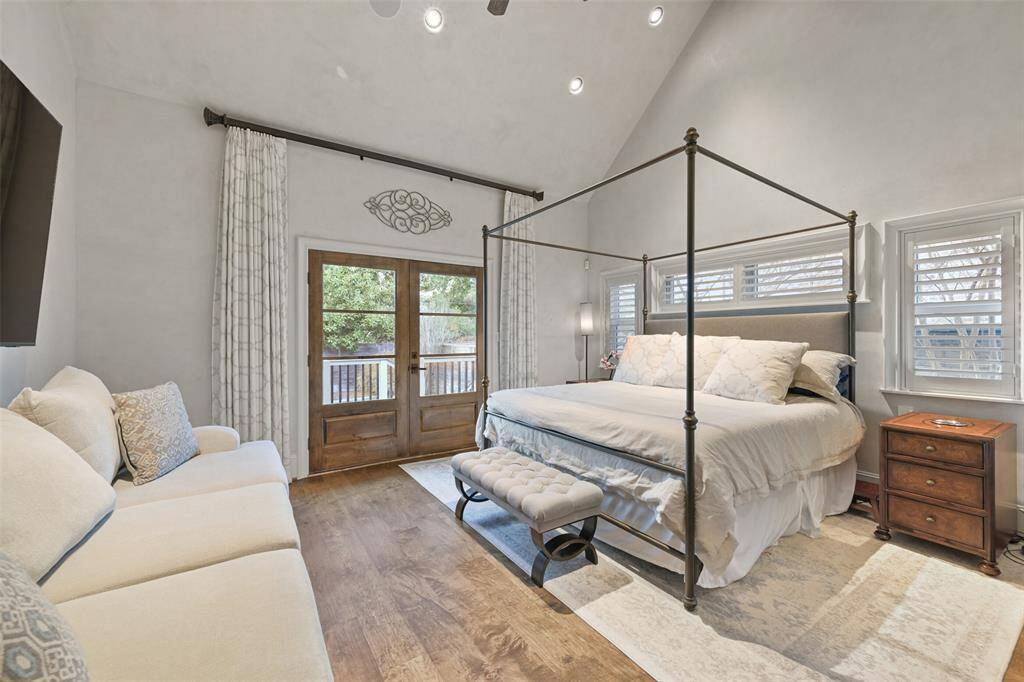 The primary suite is conveniently located on the first floor with French doors stepping out to a patio that leads directly to the pool and hot tub.