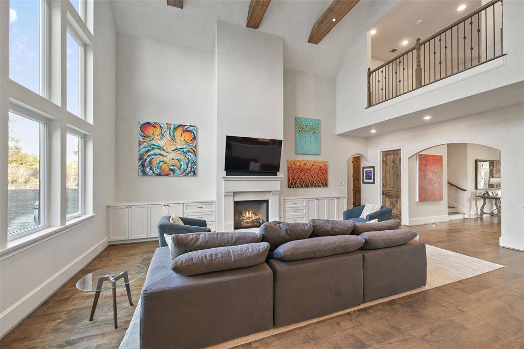The great room includes cathedral ceilings, gas fireplace and a wall of windows overlooking the back yard, pool and spa. The kitchen is open to the great room.