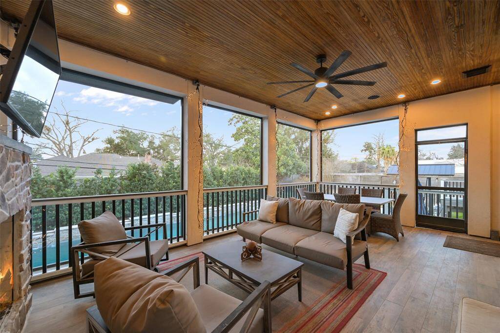 The screened porch off the breakfast room features a wood burning fireplace, beaded millwork ceiling and overlooks the pool and spa. Plumbed with gas for a grill or summer kitchen, it is the perfect place to relax and also has direct access from the first floor game room.