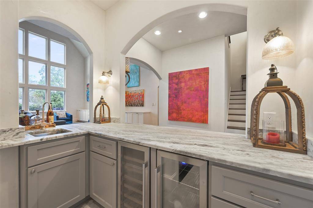 The wet bar is open to the great room and entry foyer making it perfect for entertaining.