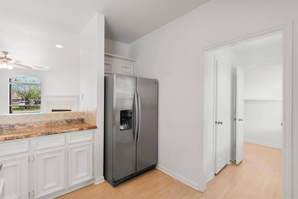 kitchen with hallway to walk-in pantry and utility room