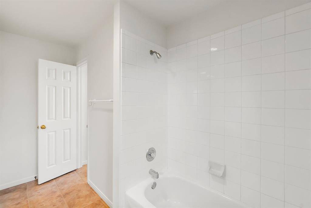 Classic tile and tub/shower combo second bathroom downstairs