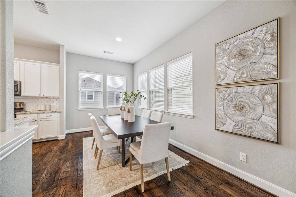 The dining space is adjacent to the living room and kitchen.