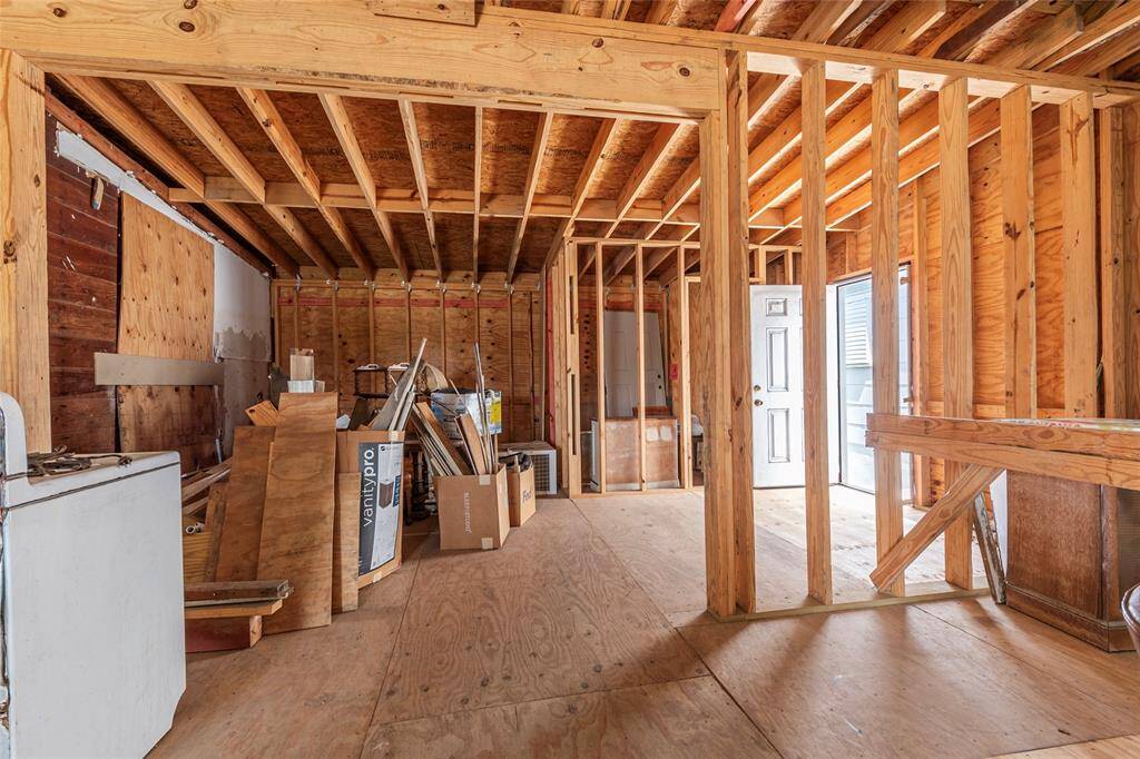 Closer look of the beginning of a bath and kitchen area.