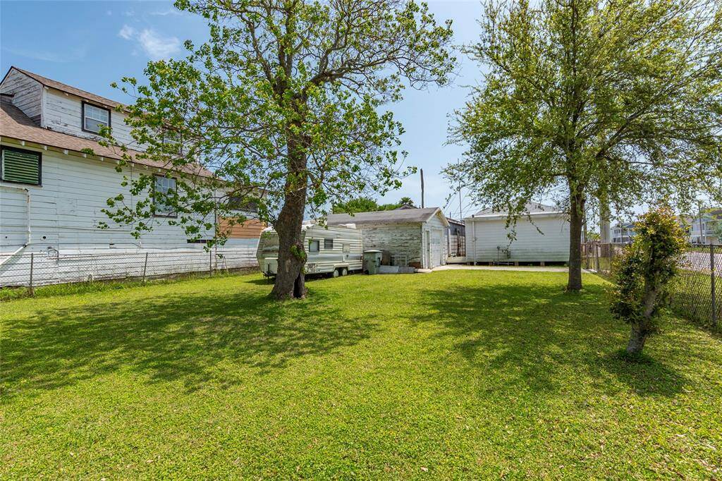 Backside view of the spacious backyard that is fenced.