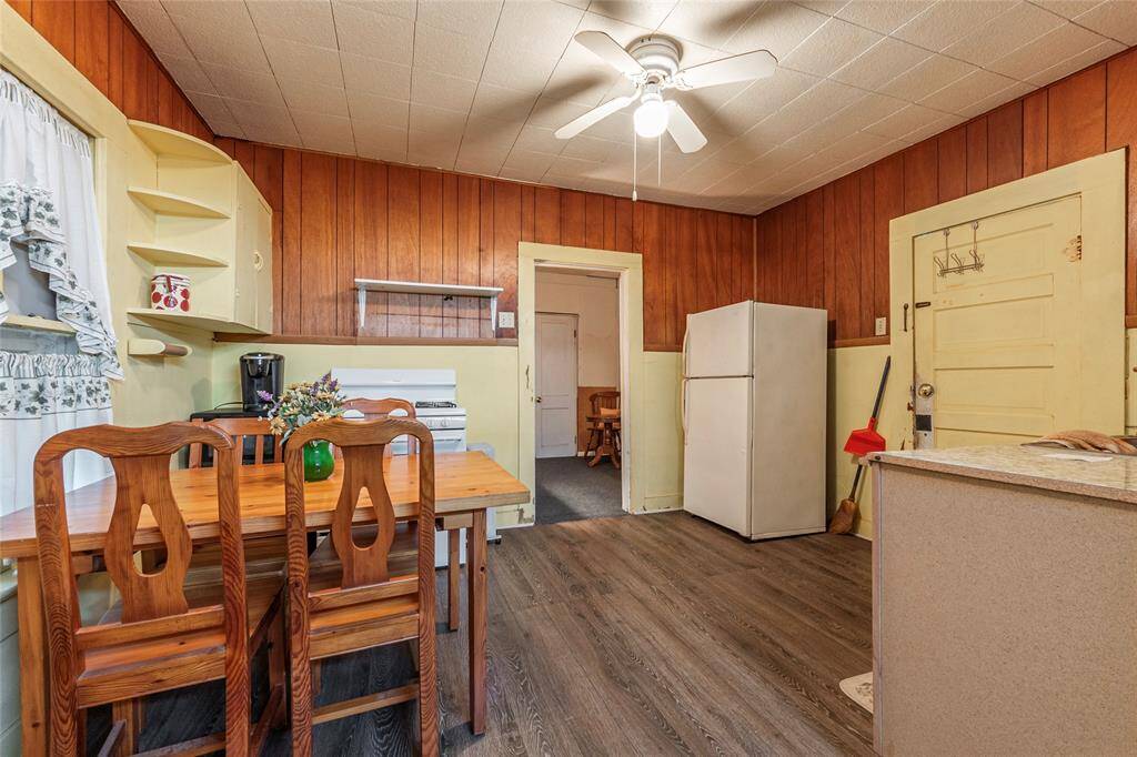 Side door leads into the kitchen/breakfast area with free standing electric stove, refrigerator and ample eat in  sitting area.