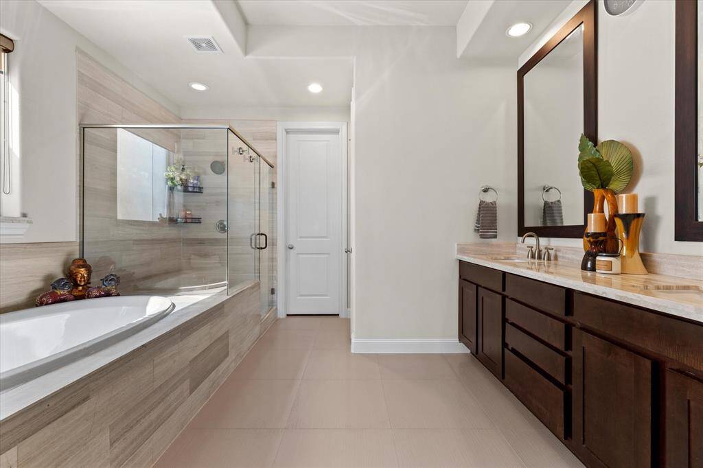 Primary bathroom with separate soaking tub and large shower.