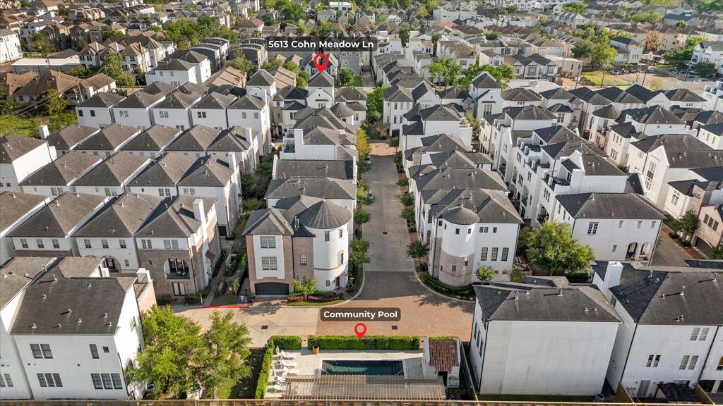 Aerial shot of pool and close proximity of home.