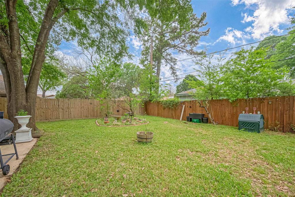 Enjoy the outdoors in this spacious, fully fenced backyard—complete with mature trees, garden beds, and plenty of green space for kids, pets, or weekend projects. Whether you’re hosting a barbecue, planting a garden, or just soaking in the sunshine, this yard offers privacy, room to roam, and endless potential.